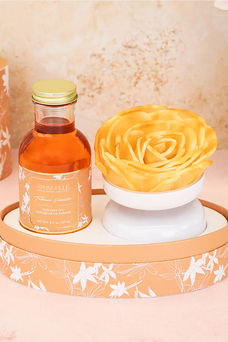 Curves & Serenity Bundle featuring a floral diffuser oil and sculpted yellow rose on a decorative tray, ideal for shapewear and self-care ambiance.
