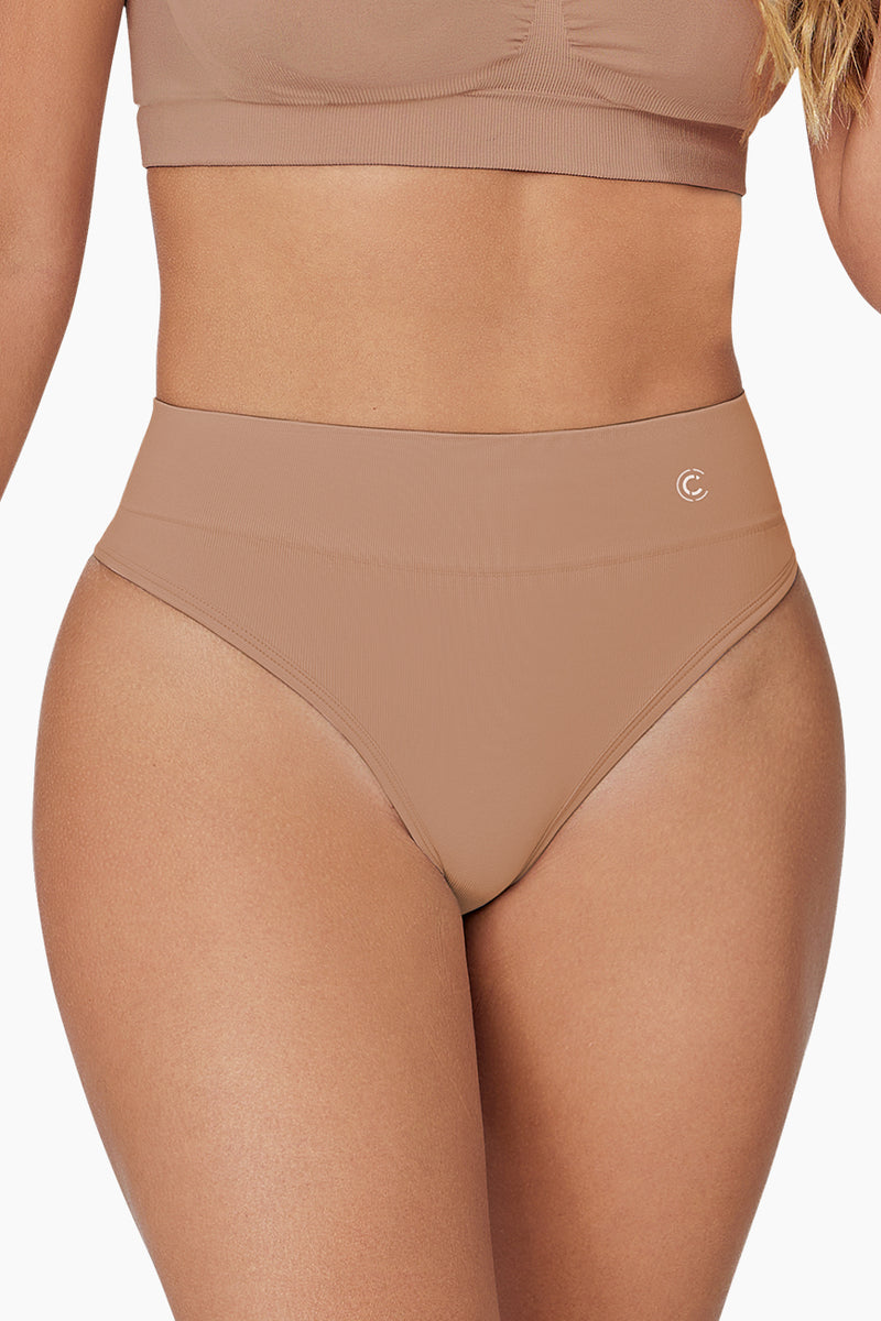 Pure Shape Thong shapewear in black with seamless design and moderate tummy control for a smooth silhouette. Ideal for everyday wear under clothing.