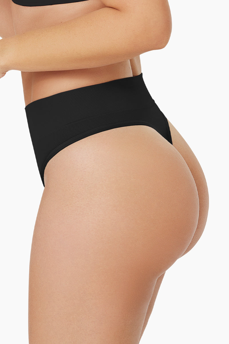 Pure Shape Thong shapewear in black with seamless design and moderate tummy control for a smooth silhouette. Ideal for everyday wear under clothing.